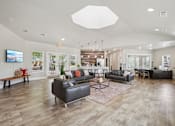 Thumbnail 38 of 70 - A spacious living room with a variety of seating options and a flat-screen TV mounted on the wall.