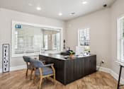 Thumbnail 45 of 70 - A reception area with a wooden desk and a blue chair.