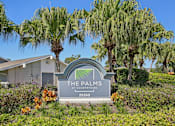 Thumbnail 25 of 25 - A sign for The Palms at Countryside with a house and palm trees in the background.