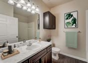 Thumbnail 8 of 42 - a bathroom with a sink and a toilet and a mirror
