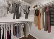 Thumbnail 9 of 11 - a closet with a rack of clothes hanging on the wall