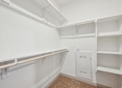Thumbnail 16 of 49 - A white closet with shelves and a white electrical box on the wall.
