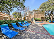 Thumbnail 33 of 45 - A pool surrounded by blue lounge chairs.