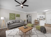 Thumbnail 2 of 52 - A living room with a grey couch, a coffee table, and a ceiling fan.