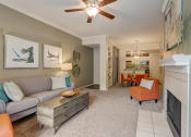Thumbnail 3 of 44 - a living room with a fireplace and a ceiling fan