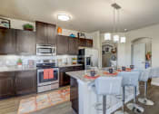 Thumbnail 3 of 50 - a kitchen with stainless steel appliances and a table with chairs