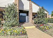 Thumbnail 19 of 42 - a sidewalk in front of a house with a flower garden