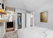 Thumbnail 8 of 15 - A bedroom with a large bed and a wardrobe.