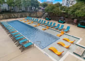 Thumbnail 36 of 50 - a swimming pool with lounge chairs and chairs around it