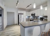 Thumbnail 4 of 44 - a kitchen with white cabinets and a counter top and a sink