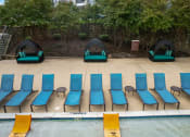 Thumbnail 42 of 50 - a row of blue and green chairs on the side of a pool