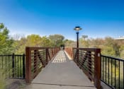 Thumbnail 37 of 37 - a bridge over a river with trees and a blue sky