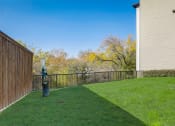 Thumbnail 35 of 37 - the backyard of a house with a yard and a fence