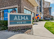 Thumbnail 49 of 49 - A sign for Alma Hub 121 is displayed in front of a building.