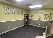 Thumbnail 17 of 19 - A room with a WASH sign and dog drawings on the wall.