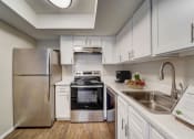 Thumbnail 3 of 27 - a kitchen with stainless steel appliances and white cabinets