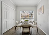 Thumbnail 5 of 45 - A dining room with a table set for four.