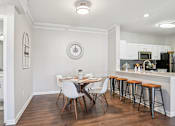 Thumbnail 4 of 70 - A kitchen with a dining table and chairs.