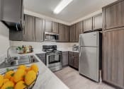 Thumbnail 5 of 42 - a kitchen with stainless steel appliances and wooden cabinets