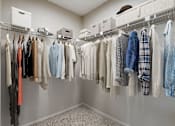 Thumbnail 6 of 21 - an image of a closet full of clothes hanging on a rack