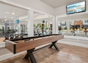 Thumbnail 48 of 70 - A room with a pool table and a television mounted on the wall.