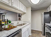 Thumbnail 3 of 21 - an open kitchen with granite counter tops and stainless steel appliances