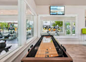 Thumbnail 49 of 70 - A room with a bowling alley and a television mounted on the wall.