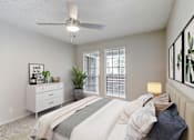 Thumbnail 5 of 21 - an empty bedroom with a bed and a ceiling fan