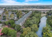 Thumbnail 42 of 44 - an aerial view of a row of houses next to a river