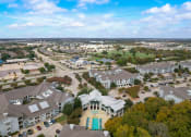 Thumbnail 47 of 50 - an aerial view of a neighborhood with houses and cars on the street