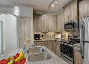 Thumbnail 5 of 52 - a kitchen with granite counter tops and stainless steel appliances