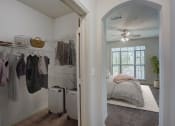 Thumbnail 11 of 52 - a bedroom with a closet and a bed and a ceiling fan