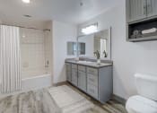 Thumbnail 8 of 44 - a bathroom with a tub and a sink and a mirror