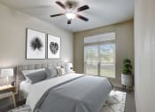 Thumbnail 10 of 36 - a bedroom with a large bed and a ceiling fan