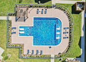 Thumbnail 40 of 43 - An aerial view of a swimming pool surrounded by a concrete patio and a grassy lawn.