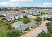 Thumbnail 63 of 70 - A large residential complex with a swimming pool and playground.