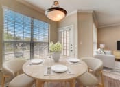 Thumbnail 3 of 42 - a dining room with a table and chairs and a large window