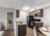 Thumbnail 3 of 37 - our apartments have a kitchen and dining room with a table and chairs