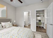 Thumbnail 20 of 52 - a bedroom with a large bed and a closet with a desk