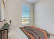 Thumbnail 11 of 44 - an empty bedroom with a bed and a window