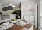 Thumbnail 3 of 45 - A modern kitchen with a dining table set for two.