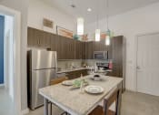 Thumbnail 9 of 37 - a kitchen with stainless steel appliances and a granite counter top