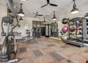 Thumbnail 16 of 42 - a gym with exercise equipment and weights on the floor and a wall of mirrors
