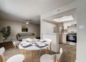 Thumbnail 2 of 27 - a living room and dining room with a white table and chairs