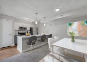 Thumbnail 3 of 41 - an open kitchen and dining room with a white table and chairs