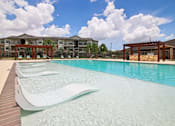 Thumbnail 39 of 57 - A large swimming pool in front of a building.