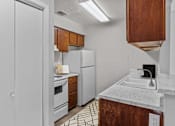 Thumbnail 12 of 37 - a kitchen with white appliances and a sink and a refrigerator