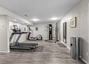 Thumbnail 20 of 37 - a gym with treadmills and exercise equipment in a home with white walls
