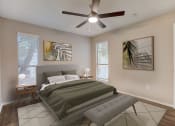 Thumbnail 6 of 11 - a bedroom with a bed and a ceiling fan