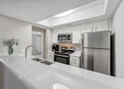 Thumbnail 3 of 15 - the preserve at ballantyne commons apartment kitchen with stainless steel appliances